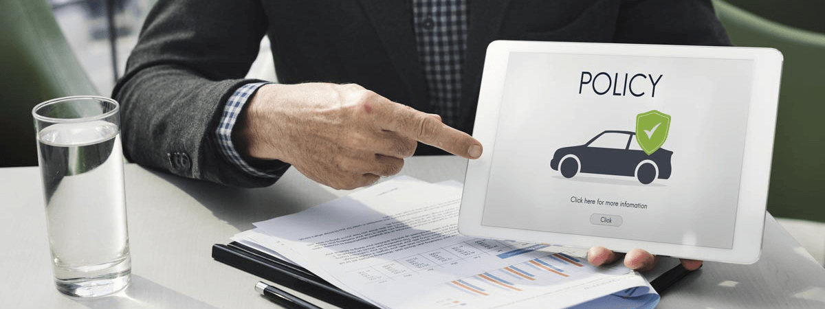Insurance agent presenting a car insurance policy on a tablet